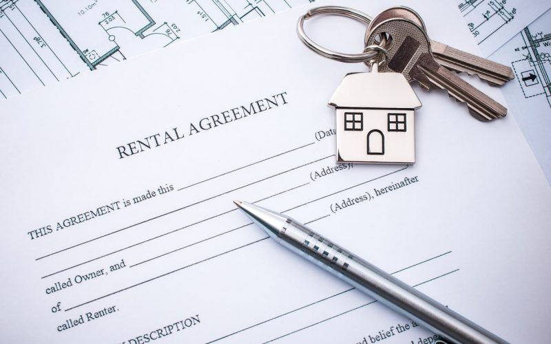 Rental agreement document with keys and pencil